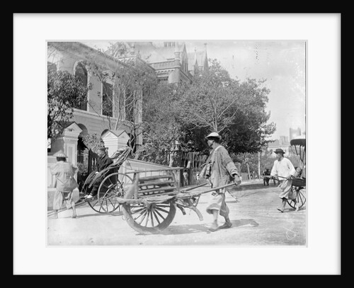 A Chinese man pushing a wooden wheelbarrow with a rickshaw in the background by Kenneth Hurlstone Jones