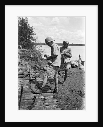 A British government official checking mangrove poles by Alan Villiers