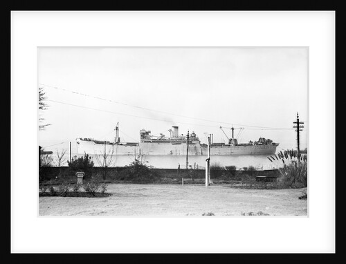 Cargo liner 'Manchester Port' (1935) under tow with topmasts struck by unknown