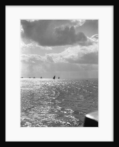 The sunlit North Sea from the harbour entrance with a number of trawlers under sail on the horizon at Lowestoft, Suffolk by Smiths Suitall Ltd.