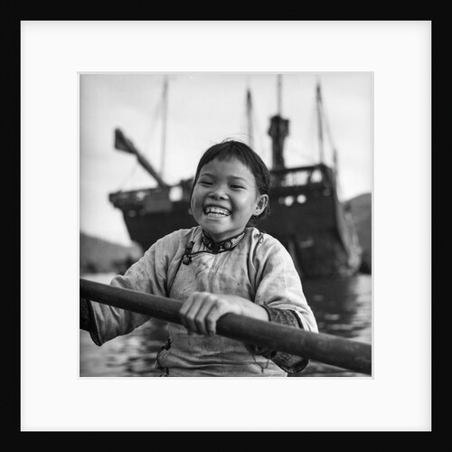 A portrait of a young girl in a sampan in Aberdeen harbour, Hong Kong. by David Watkin Waters