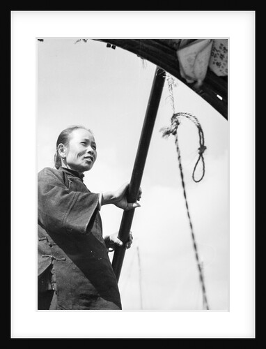 A middle aged Chinese woman in a sampan in Hong Kong harbour by David Watkin Waters