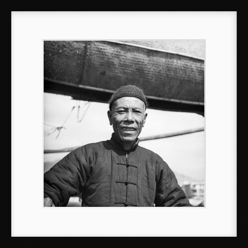 A portrait of one of the crew of a Canton salt junk on board his vessel at Sham Shui Po, Hong Kong by David Watkin Waters