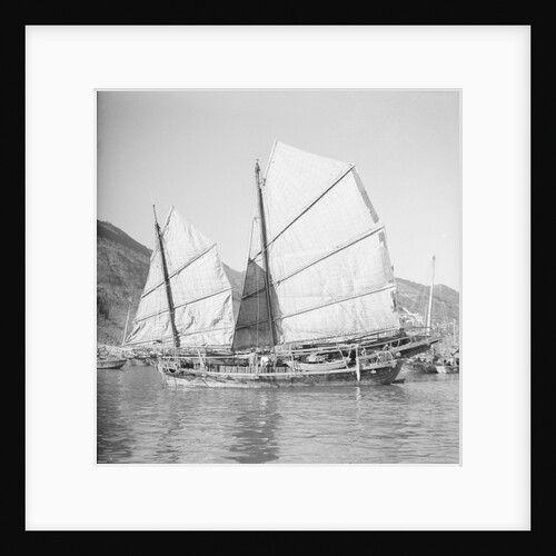An Aberdeen fisher type junk under sail in Hong Kong harbour. by David Watkin Waters