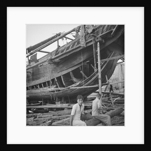 A close port side view of a Hong Kong fisher d.w. type junk repairing on a slipway at Hong Kong by David Watkin Waters