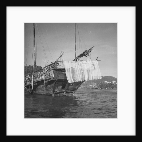 A port quarter view of an Aberdeen frame stern fisher type junk in Hong Kong harbour by David Watkin Waters