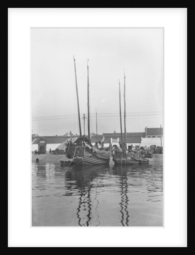A bow view of two Tsingtao fisher type junks moored stern-on to the shore at Tsingtao by David Watkin Waters