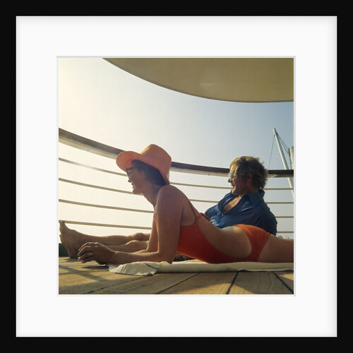 A couple relax and enjoy the sea view on board an unspecificed cruise liner by unknown