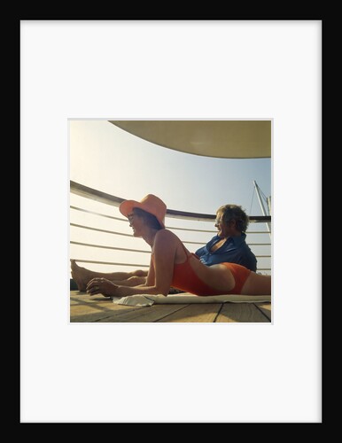 A couple relax and enjoy the sea view on board an unspecificed cruise liner by unknown