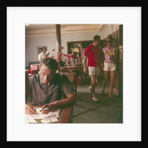 Passengers on board an unspecified cruiser liner pass the time by writing and walking the ship by Marine Photo Service