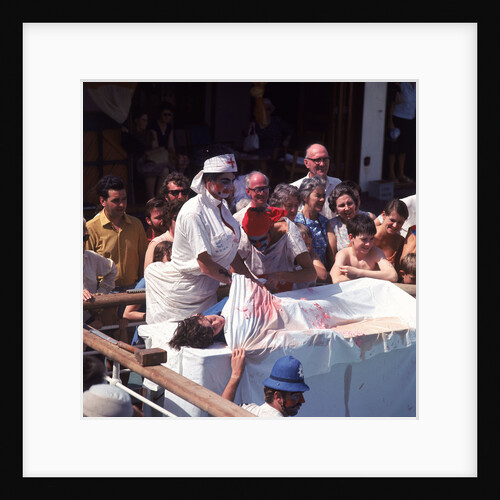 Macabre comic entertainment aboard an unspecified cruise ship - perhaps a variant of the Crossing the Line (the Equator) ceremony? by Marine Photo Service