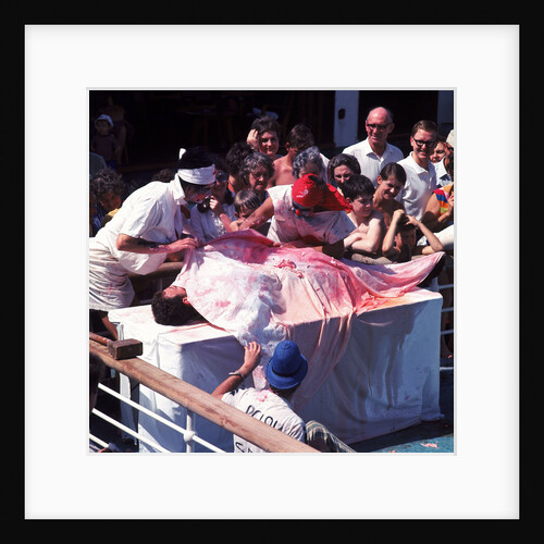 Macabre comic entertainment aboard an unspecified cruise ship - perhaps a variant of the Crossing the Line (the Equator) ceremony? by Marine Photo Service