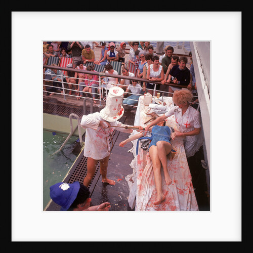Macabre comic entertainment aboard an unspecified cruise ship, with a female passenger prostrate on a bloody slab - perhaps a variant of the Crossing the Line (the Equator) ceremony? by Marine Photo Service