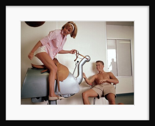 Exercise, hilarity and hijinks combined: a couple enjoy the novel pleasures of a 'bucking bronco' machine on board an unspecified cruise ship by Marine Photo Service