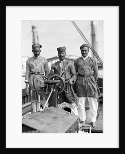 Three Lascars of the 'Viceroy of India' (1929), standing behind the wheel of one of the ship's tenders by Marine Photo Service