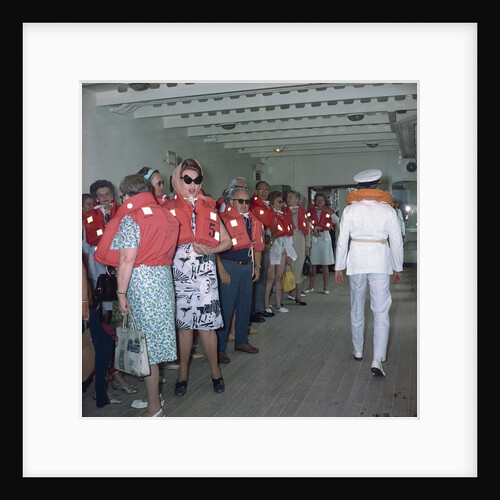 A group of passengers with lifejackets aboard 'Kungsholm' (1966), undergoing life boat drill by Marine Photo Service