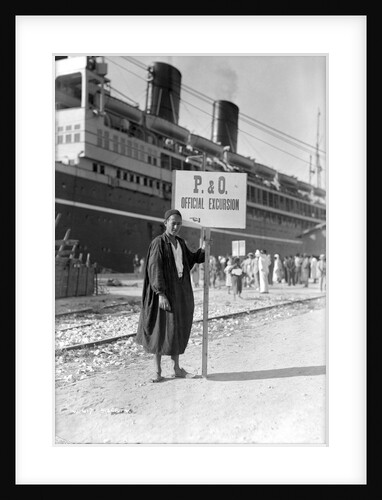 A Tunisian tour guide posing with his official P & O sign, Bizerte, Tunisia by Marine Photo Service