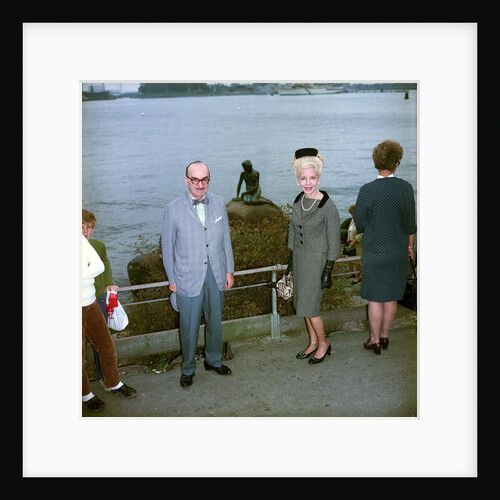 Unidentified couple posing in front of the Mermaid sculpture, Copenhagen, Denmark by Marine Photo Service