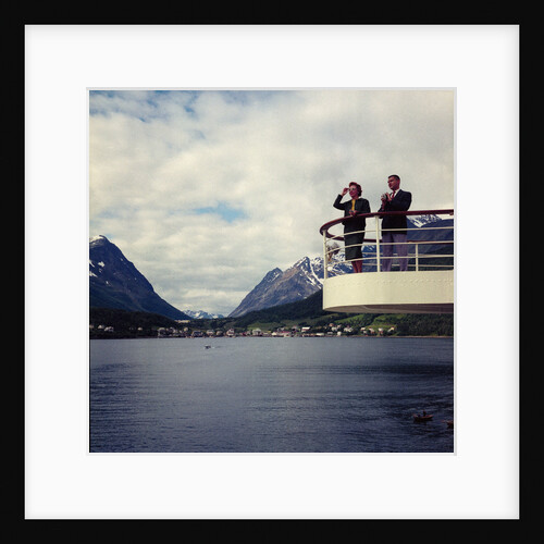 A view looking towards Lyngseidt in the background: an unidentified couple stand on the after wing of 'Gripsholm' (1957) by Marine Photo Service
