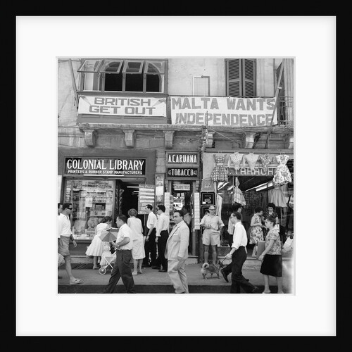 A view of shops with anti-British and pro-Independence signs, possibly on Kings Street, Valetta, Malta. by Marine Photo Service