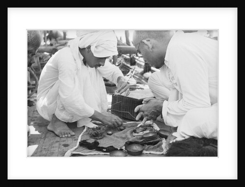 Pearl buyers examining pearls by Alan Villiers
