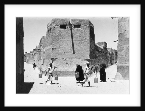 Women and water carriers on the street, Kuwait by Alan Villiers