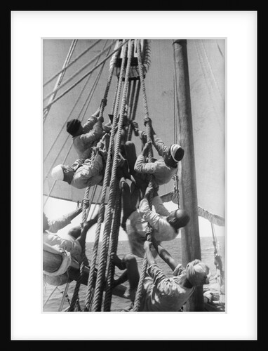 Sailors climbing the halyard blocks by Alan Villiers