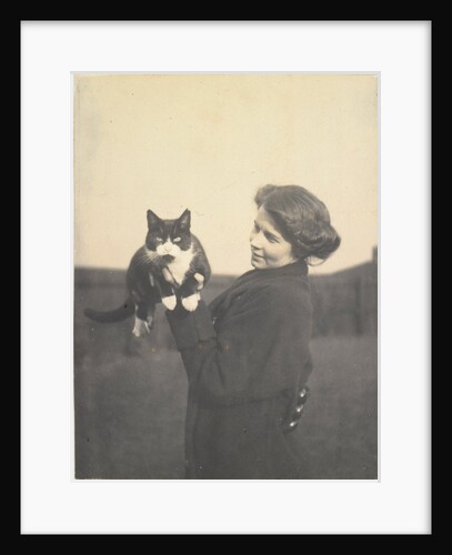 An informal photograph of Kathleen Alice Taylor holding Slabbie the black/white cat in her hands by Unknown