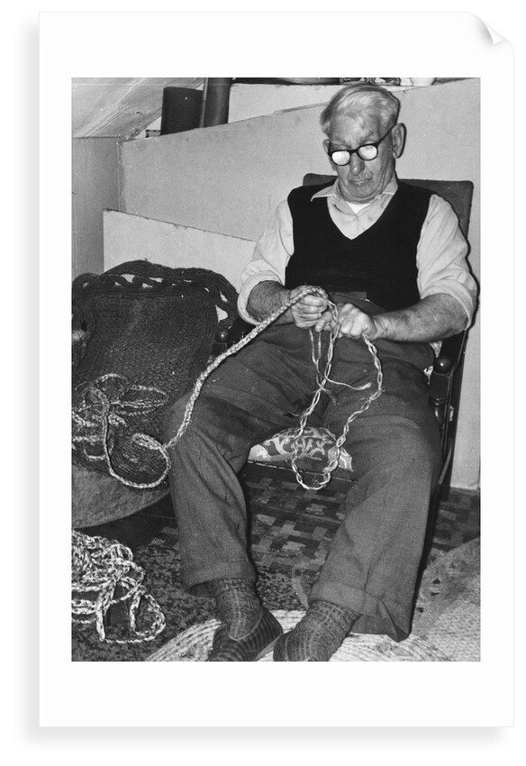 Mr L. Marling making repe mats by Unknown