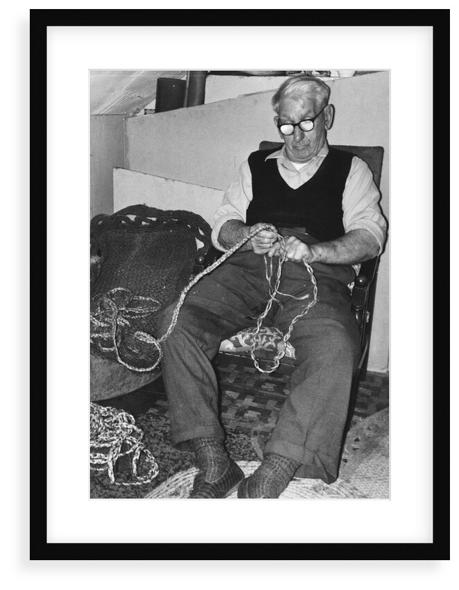Mr L. Marling making repe mats by Unknown