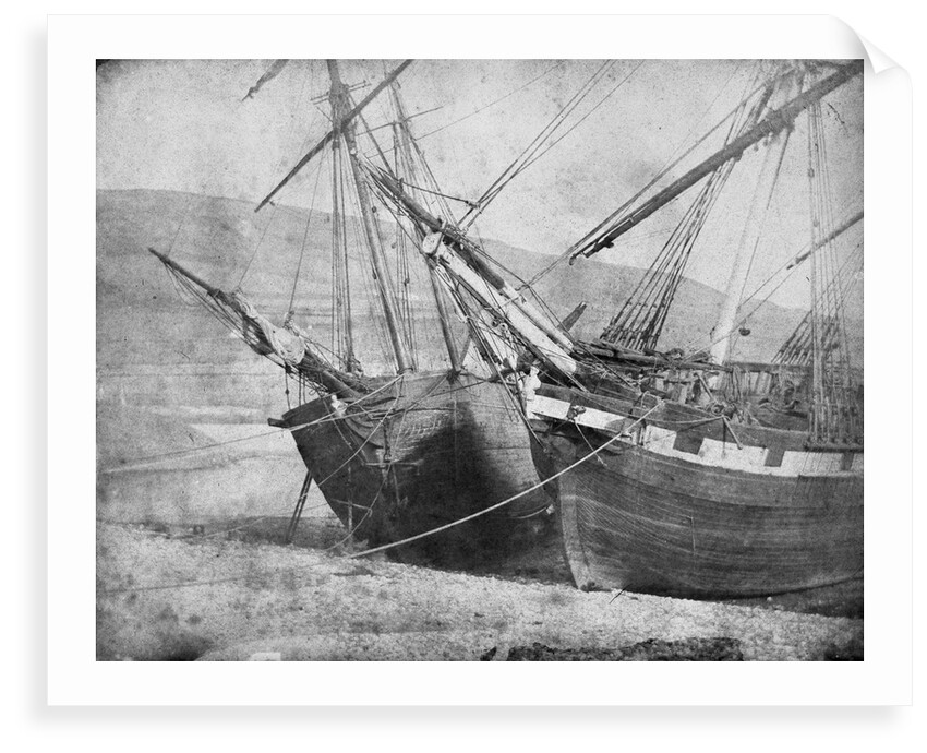Bow view of two unidentified vessels at low tide by unknown