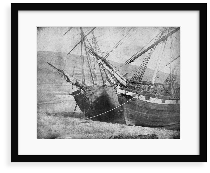 Bow view of two unidentified vessels at low tide by unknown