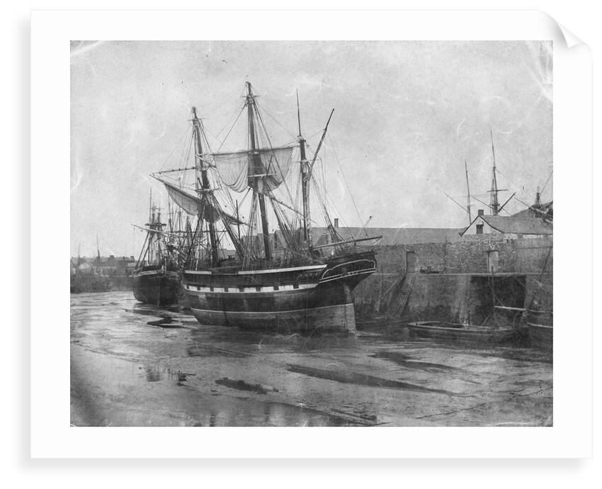 Stern quater view of copper ship and others aground at low tide by unknown