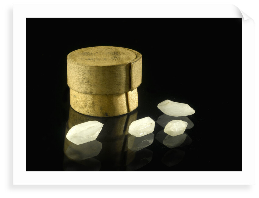 Pill box containing four cloudy white crystals by Unknown