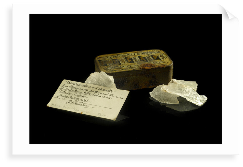 A tobacco tin containing pieces of quartz. by Unknown