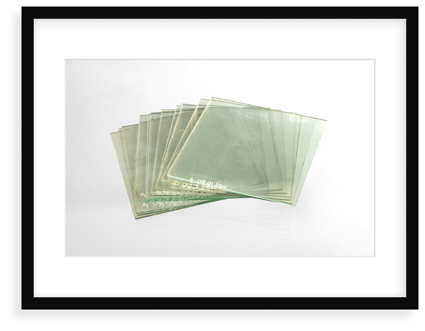 Thirteen clean cut glass squares in a box by unknown