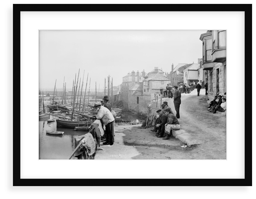 Newlyn Harbour, Cornwall. The old harbour with fishermen looking out to sea. by Francis Frith & Co.