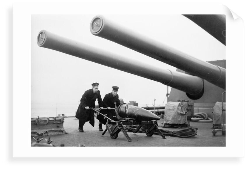 Two ratings pushing a 14-inch shell on a trolley on the battleship 'King George V' (1939). King George V carried about 800 shells for her 10 guns when loaded. by unknown