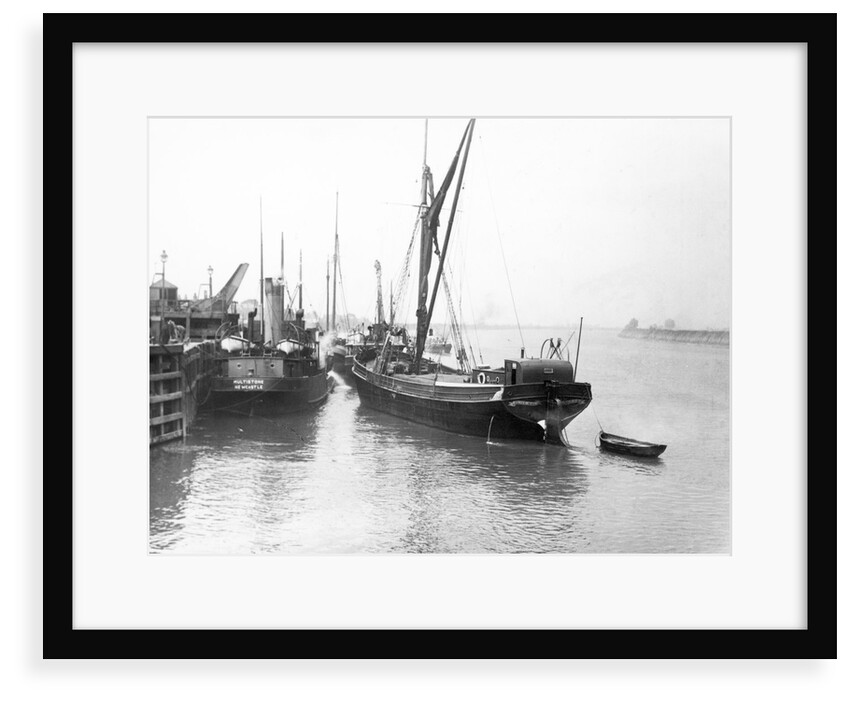 The 'Olive May' (1920), a port quarter view of the barge motoring to quayside with her tender in tow (sails furled) by Anonymous