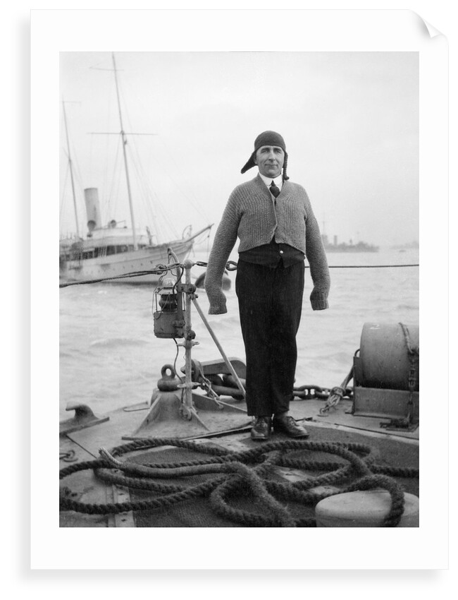 Gunner William G. Worsh of the destroyer 'Swallow' proudly showing off his latest comforts from home, a hand-knitted cardigan and balaclava by Unknown