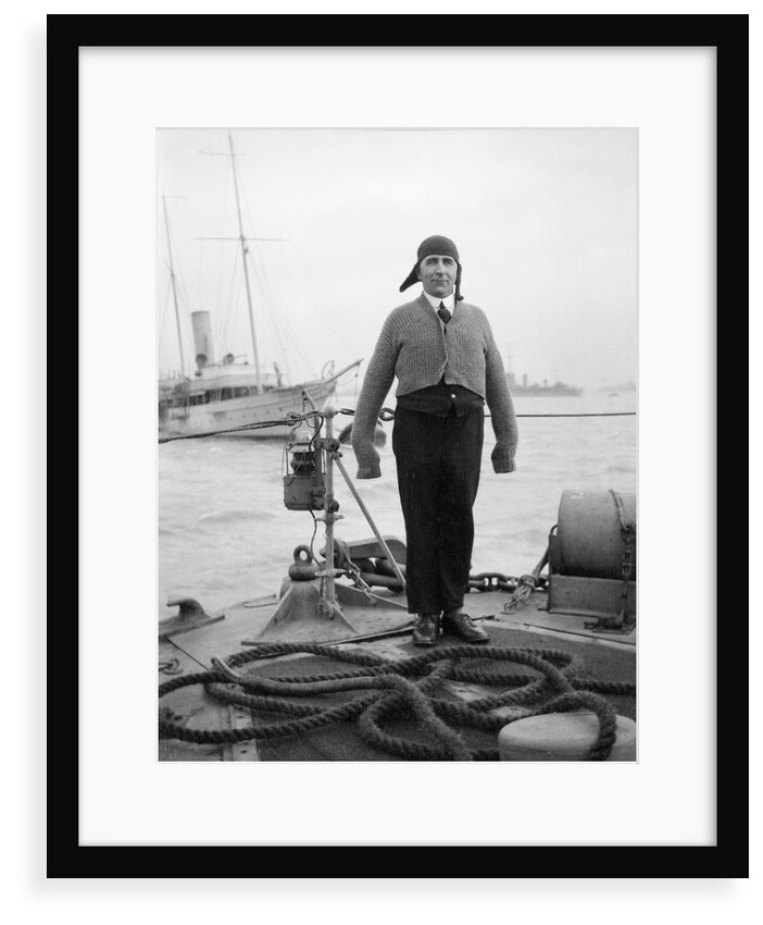 Gunner William G. Worsh of the destroyer 'Swallow' proudly showing off his latest comforts from home, a hand-knitted cardigan and balaclava by Unknown