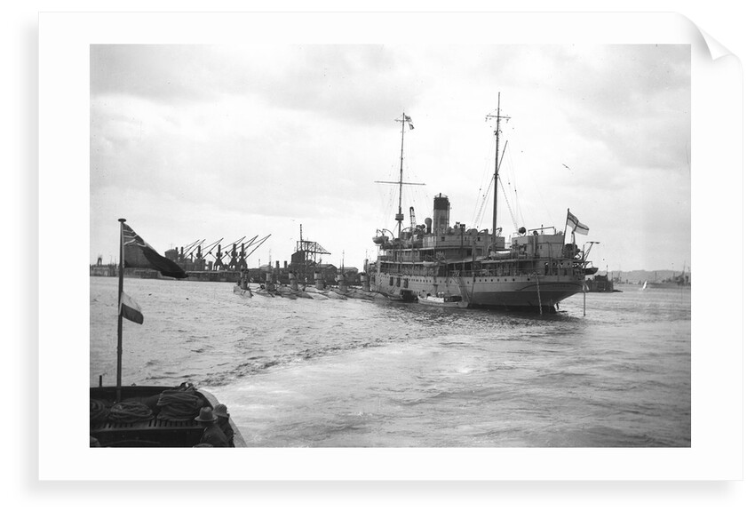 HMS 'Titania' (1915) submarine depot ship, moored at Portland with 6 submarines alongside by unknown