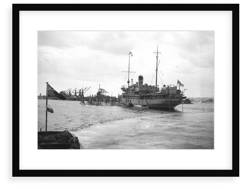 HMS 'Titania' (1915) submarine depot ship, moored at Portland with 6 submarines alongside by unknown