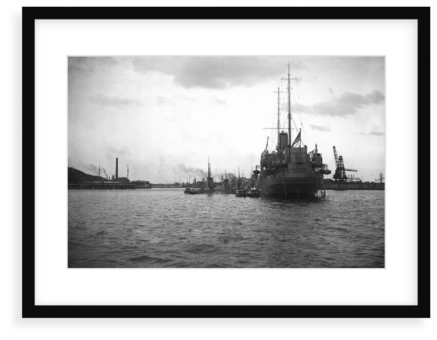HMS 'Titania' (1915) submarine depot ship, moored at Portland with 4 submarines alongside by unknown