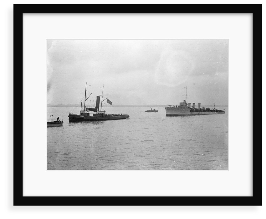 Rescue tug HMS 'Vanquisher' (1899) entering the floating dock at Harwich with the mined destroyer 'Thisbe' (1917) in tow by unknown