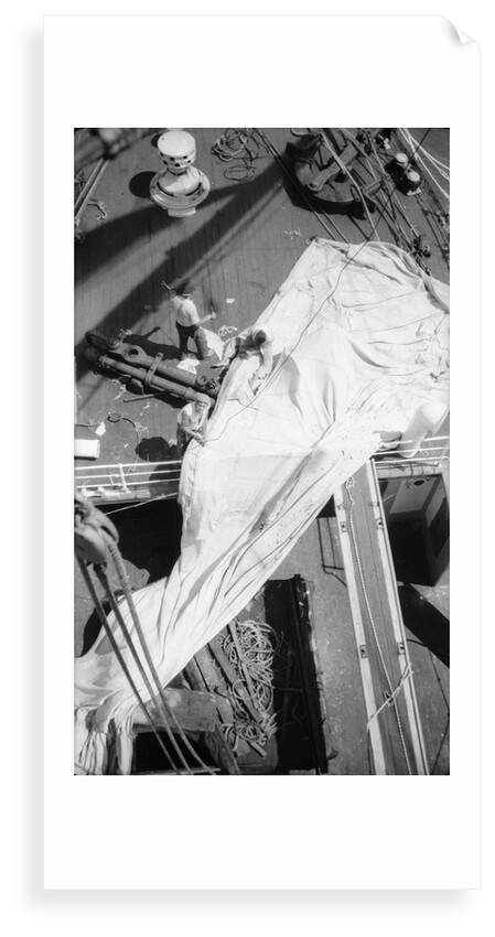 Repairing a spread sail on the forecastle by Alan Villiers