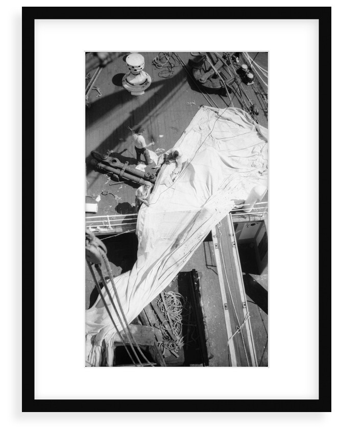 Repairing a spread sail on the forecastle by Alan Villiers