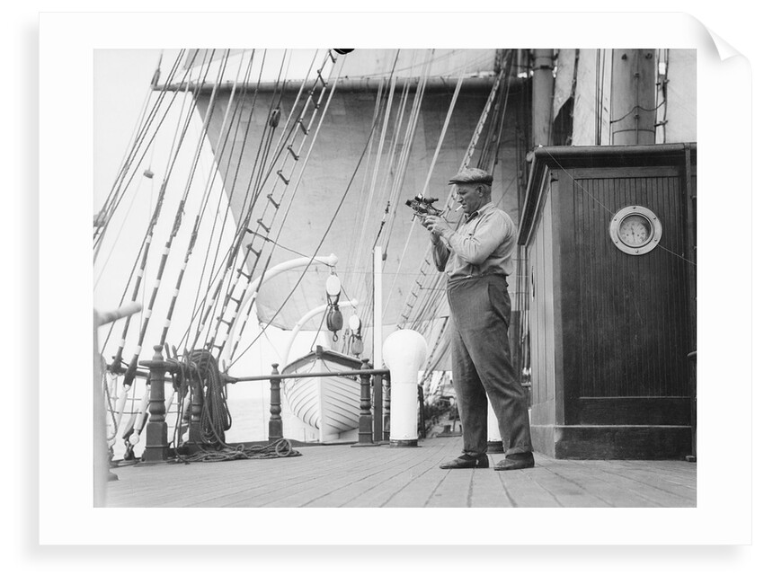 Captain Ruben de Cloux examining the reading on his sextant by Alan Villiers
