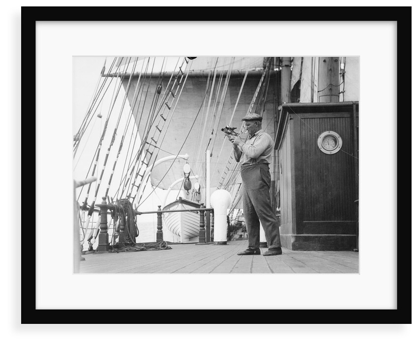 Captain Ruben de Cloux examining the reading on his sextant by Alan Villiers
