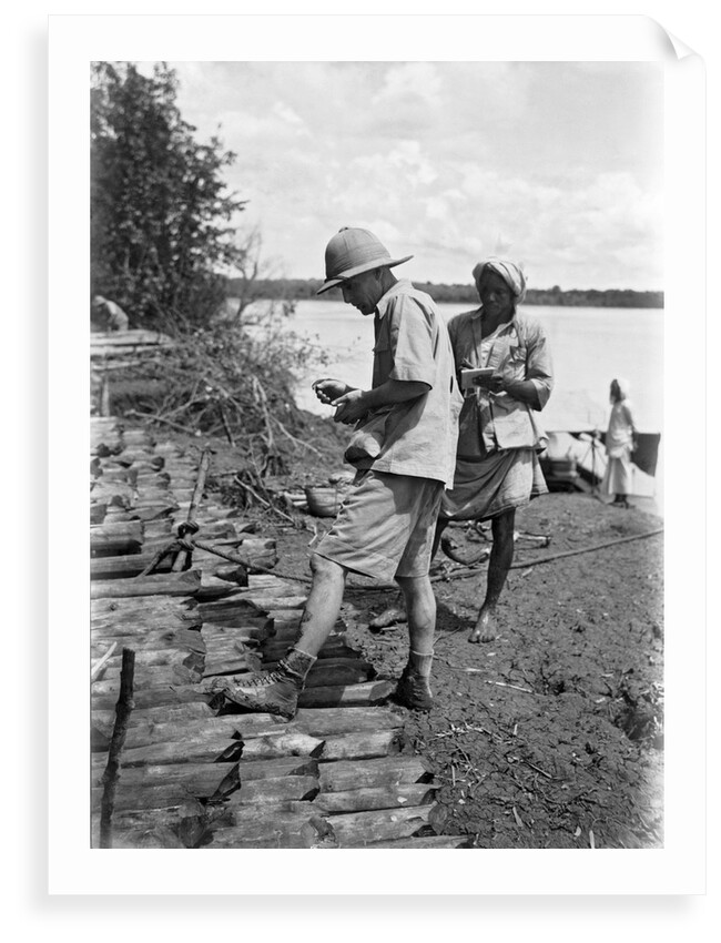 A British government official checking mangrove poles by Alan Villiers